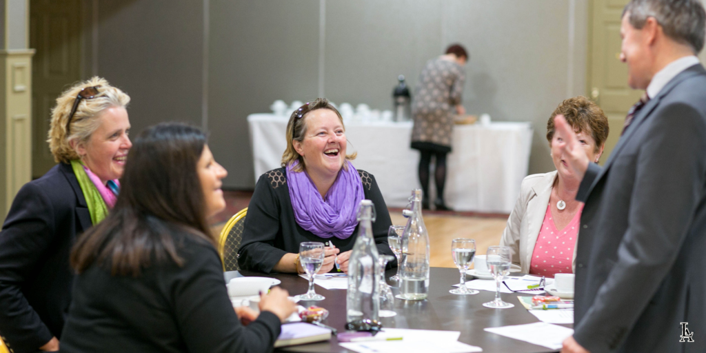 A group of professionals enjoying a meeting and collaboration session.