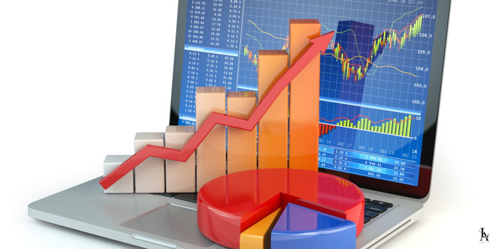 A laptop displaying financial charts with 3D bar and pie charts placed on the keyboard, illustrating business growth and analytics.